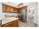 Traditional kitchen with stainless steel refrigerator, wood cabinets, and light countertops at 84 Sycamore Lake Rd, Siler City, NC 27344