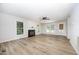 Spacious living room with a fireplace, ceiling fan, and plenty of natural light at 84 Sycamore Lake Rd, Siler City, NC 27344