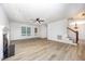 Open-concept living room featuring a fireplace, ceiling fan, and wood flooring at 84 Sycamore Lake Rd, Siler City, NC 27344
