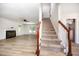 Bright living room with fireplace, staircase, and lots of natural light at 84 Sycamore Lake Rd, Siler City, NC 27344