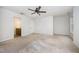 Large main bedroom features a ceiling fan, carpet floors, bright windows, and a closet at 84 Sycamore Lake Rd, Siler City, NC 27344