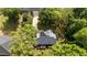 Birds-eye view of a house with solar panels surrounded by mature trees at 909 Alderleaf Dr, Fuquay Varina, NC 27526