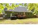 The backyard features a spacious lawn, patio, and a green exterior with a grill for outdoor dining at 909 Alderleaf Dr, Fuquay Varina, NC 27526