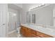 Bright bathroom features double sinks, wood vanity, and glass-enclosed shower at 909 Alderleaf Dr, Fuquay Varina, NC 27526
