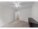 Neutral bedroom with ceiling fan, carpet, closet, and dark cabinet at 909 Alderleaf Dr, Fuquay Varina, NC 27526