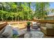 Inviting wooden deck with patio furniture and wooded backdrop at 909 Alderleaf Dr, Fuquay Varina, NC 27526