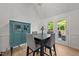 Open concept dining area features modern decor, table with seating, and a glass door to the exterior at 909 Alderleaf Dr, Fuquay Varina, NC 27526