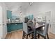 Open concept kitchen with stainless appliances, turquoise cabinetry, an eat-in dining area, and hardwood floors at 909 Alderleaf Dr, Fuquay Varina, NC 27526