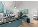 Contemporary kitchen features stainless appliances, turquoise cabinets, black countertops, and bar seating at 909 Alderleaf Dr, Fuquay Varina, NC 27526
