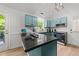 Bright kitchen featuring blue cabinetry, black countertops, modern appliances, and lots of natural light at 909 Alderleaf Dr, Fuquay Varina, NC 27526