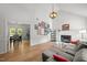 Open living room with fireplace, decor, lots of natural light, and access to the kitchen and dining area at 909 Alderleaf Dr, Fuquay Varina, NC 27526