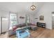Inviting living room with wood floors, vaulted ceilings, fireplace, and a sectional sofa with accent pillows at 909 Alderleaf Dr, Fuquay Varina, NC 27526