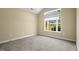 Bedroom with neutral walls, carpet, base trim, and large picture window at 924 Carolina Bell Rd, Apex, NC 27502