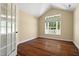Bright room featuring hardwood floors, vaulted ceilings and a window overlooking a white picket fence at 924 Carolina Bell Rd, Apex, NC 27502
