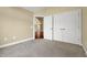 Bedroom featuring carpet, neutral walls, base trim, and a double-door closet at 924 Carolina Bell Rd, Apex, NC 27502