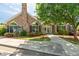 Clubhouse exterior features a stone facade, arched windows, a sign, and manicured landscaping at 924 Carolina Bell Rd, Apex, NC 27502