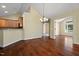 Open-concept dining room with hardwood floors, decorative lighting, and access to the kitchen and bedroom at 924 Carolina Bell Rd, Apex, NC 27502