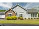 Home's exterior shows stone and vinyl siding, manicured landscaping, and white-framed windows at 924 Carolina Bell Rd, Apex, NC 27502