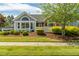 Charming home featuring a well-manicured lawn, tidy landscaping, and a quaint white picket fence at 924 Carolina Bell Rd, Apex, NC 27502