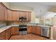 Spacious kitchen features hardwood floors, stainless steel appliances, granite countertops, and wooden cabinets at 924 Carolina Bell Rd, Apex, NC 27502