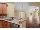 Kitchen with stainless steel appliances and granite countertops opens to a large, well-lit living room at 924 Carolina Bell Rd, Apex, NC 27502