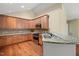 Well-lit kitchen features wood cabinets, granite countertops, stainless steel appliances, and hardwood floors at 924 Carolina Bell Rd, Apex, NC 27502