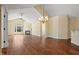 Open living room with hardwood floors, fireplace, ceiling fan and decorative lighting at 924 Carolina Bell Rd, Apex, NC 27502
