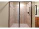 Bathroom featuring walk-in shower with glass enclosure, bench, grab bar, and tiled surround at 924 Carolina Bell Rd, Apex, NC 27502