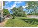 Well-manicured lawn featuring mature trees, patio with seating, and water views at 10 Marsh Landing Ct, Durham, NC 27703