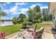 Beautiful backyard featuring a patio with an outdoor grill, seating, and view of the water at 10 Marsh Landing Ct, Durham, NC 27703