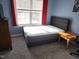 Bedroom with carpet, dresser, and a bed with a gray headboard at 10 Marsh Landing Ct, Durham, NC 27703