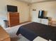 Cozy bedroom featuring a TV, dresser, mini fridge, microwave, and comfortable bed at 10 Marsh Landing Ct, Durham, NC 27703