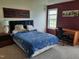 Bedroom featuring carpet, desk, and a bed with a patterned blue quilt at 10 Marsh Landing Ct, Durham, NC 27703