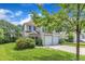 Charming two-story home with a two car garage, manicured lawn, and stone walkway at 10 Marsh Landing Ct, Durham, NC 27703