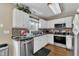 Bright kitchen featuring white cabinets, stainless steel appliances, and a decorative tile backsplash at 10 Marsh Landing Ct, Durham, NC 27703