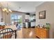 Well-lit kitchen featuring wood floors, stainless steel appliances, and sliding glass doors leading to a water view at 10 Marsh Landing Ct, Durham, NC 27703