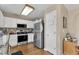 Well lit kitchen features stainless steel appliances, a microwave, and a white pantry door at 10 Marsh Landing Ct, Durham, NC 27703