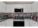 Clean, updated kitchen with modern stainless steel appliances and granite countertops at 10 Marsh Landing Ct, Durham, NC 27703