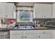 Bright kitchen with white cabinets, window and stainless-steel appliances at 10 Marsh Landing Ct, Durham, NC 27703
