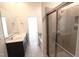 Modern bathroom featuring a glass enclosed shower, double vanity, and neutral color palette at 1033 Talisker Way # 16, Burlington, NC 27215
