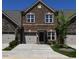 Charming townhome featuring a brick facade, attached garage, and manicured front lawn at 1033 Talisker Way # 16, Burlington, NC 27215