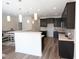 Modern kitchen with dark cabinetry, white countertops, pendant lighting, and stainless steel appliances at 1033 Talisker Way # 16, Burlington, NC 27215