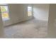 Bright bedroom with neutral carpet and two windows at 104 Elmsford St, Durham, NC 27703