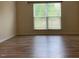 Bright bedroom with wood-look floors and natural light streaming through the window at 104 Elmsford St, Durham, NC 27703