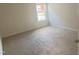Cozy bedroom with neutral carpet and natural light at 104 Elmsford St, Durham, NC 27703
