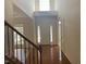 Bright foyer with high ceilings, hardwood floors, and staircase with wood and iron railing at 104 Elmsford St, Durham, NC 27703
