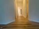 Hallway with wood-look floors leading to various rooms at 104 Elmsford St, Durham, NC 27703