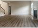 Open living space with a modern fireplace, light-colored walls, and vinyl plank flooring at 104 Elmsford St, Durham, NC 27703