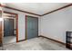 This is a empty bedroom with gray walls, a double door closet, and dark wooden trim at 1100 Cardinals Knob, Rocky Mount, NC 27804