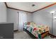 Cozy bedroom with light grey walls and a bed with a dinosaur-themed blanket at 1100 Cardinals Knob, Rocky Mount, NC 27804